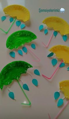 paper plate umbrellas made to look like raindrops on a white table top