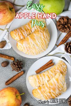 two white plates topped with apple hand pies next to an apple and cinnamon stick