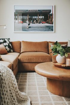 a living room filled with furniture and a large painting hanging on the wall above it