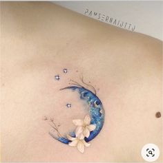 a woman's stomach with a tattoo on it that has butterflies flying around the moon