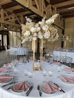 the table is set with silverware and pink napkins for an elegant wedding reception