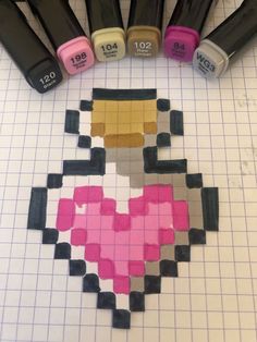 some sort of pixel art with different colors and shapes on the table next to markers