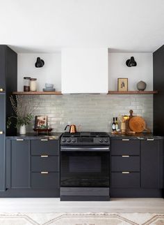 a kitchen with black cabinets and an oven