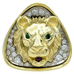 Ring Size: 12.5 Embrace bold luxury with this captivating lion statement ring, a true 18 karat gold masterpiece that exudes power and elegance. At the heart of this magnificent creation is a regal lion’s face, meticulously crafted to capture the fierce beauty and strength of the king of the jungle. The lion's eyes glisten with vivid emeralds, while a striking ruby rests in its mouth, symbolizing its majestic dominance. Encircling the lion’s head is a breathtaking pavé of diamonds, each one carefully set to enhance the ring’s dazzling brilliance and add a touch of opulence. The contrast between the lion’s finely detailed features and the sparkle of the diamonds creates an unforgettable combination of artistry and luxury. Crafted for those who appreciate bold, statement-making jewelry, this Between The Lions, Lion Eyes, Lion Ring, King Of The Jungle, Power Symbol, Head Ring, Lion Head, Diamond Gemstone, Cocktail Rings