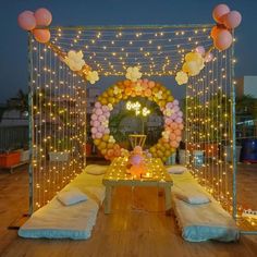 an outdoor party setup with balloons and lights