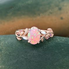 a pink opal ring with leaves on it