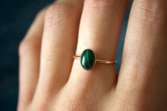 STUNNING handmade Malachite ring ✨ * Listing covers just the single malachite ring, other rings shown are sold separately.  Due to each stone being natural, each stone will vary in color, design, and clarity Beautiful 8x6mm natural oval Malachite gemstone ✨ Malachite is a green copper carbonate mineral. It is part of the monolithic crystal system and has a silky luster. Malachite is often used as an ore of copper. It has an opaque transparency and sometimes has a patterned surface. Malachite is a rich shade of green and its meaning is transformation and positive change. This gem was loved by the Greeks and the Egyptians, and used as a protective gem from curses and negative energies.  It is a stone that takes its name from the Greek word for malakos - meaning soft. While it is a stone that Malachite Ring, Crystal System, Malachite Rings, Green Copper, Jade Ring, Ring Minimalist, Minimalist Ring, Minimalist Rings, Favorite Rings