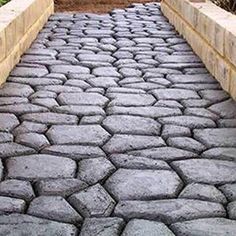 an image of a cobblestone walkway in the garden or yard that looks like it could be paved