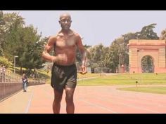 a shirtless man running on a tennis court