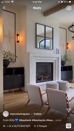 a living room filled with furniture and a fire place in front of a mirror on the wall