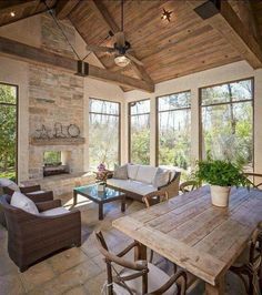 a living room filled with lots of furniture next to a fire place in a house