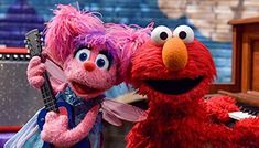 the sesame street characters are playing music together