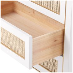 an open drawer with bamboo inserts on the bottom and side panels in white painted wood