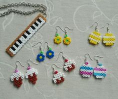 several pieces of beaded jewelry are displayed on a white tablecloth with a keychain