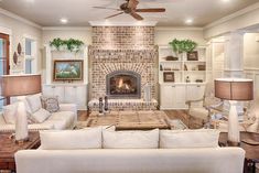 a living room filled with furniture and a fire place in the middle of a room