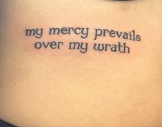 a tattoo saying my merry prevails over my urath on the back of a woman's stomach