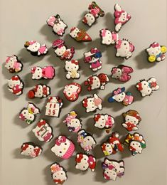 a bunch of hello kitty magnets sitting on top of a table