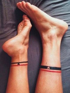 two people with matching wristbands on their wrists, one is holding the other's hand