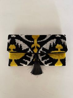 This uzbek patchwork clutch bag with tassel  will make a great birthday gift for the ladies in your family. It combines the modern and traditional, the practical and artistic. Use it as an accessory that will turn heads and make every outfit stand out. The bag is decorated with a fashionable tassel.Put your keys, phone and some special secret things in it and you'll complete that chic look you need for that big occasion or long-awaited party.  The traditional ikat fabric is handwoven with a lot Patchwork Clutch, Bag With Tassel, Velvet Clutch, Silk Ikat, Clutch Purse Evening, Ikat Fabric, Great Birthday Gifts, Evening Clutch, Purse Clutch