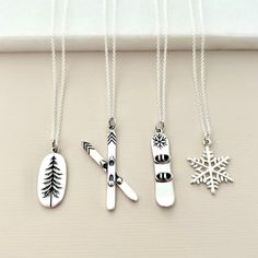 "Thrill winter sports lovers with these sterling silver snowboard, ski, pine tree or snowflake charm necklaces. The perfect gift for a winter sports lover. Choose from a 16\", 18\" or 20\" chain. All materials are sterling silver and are wrapped in our signature orange gift box ready for gift giving. Tree Charm (mm): 20 x 10 Snowboard Charm (mm): 34 x 7 Skis Charm (mm): 36 x 14 Snowflake Charm (mm): 20 x 10" Orange Gift Box, Outdoor Lover Gifts, Snowboarding Gifts, Giving Tree, Oranges Gift, Ski Gifts, Silver Gift Wrap, Ski Accessories, Tree Necklace