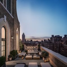 an outdoor seating area on the roof of a building