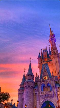 the castle is lit up at night with its lights on