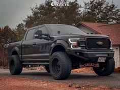 a black truck parked in front of a house