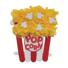 a bunch of yellow flowers are in a popcorn pop holder with the word popcorn written on it