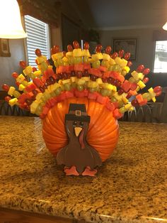 a turkey made out of candy sitting on top of a counter next to a lamp