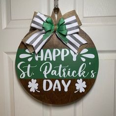 a st patrick's day sign hanging on a door with green and white bows