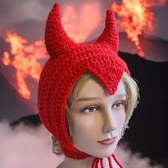 a mannequin wearing a red knit devil hat