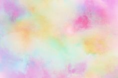 a pastel colored background with lots of different colors and shapes in the sky,