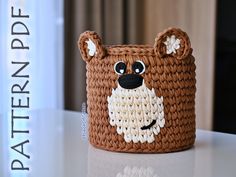 a crocheted bear basket sitting on top of a table