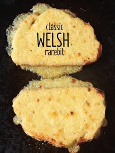 two pieces of bread sitting on top of a black surface with the words classic welsh rarebit