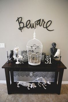 there is a birdcage and skeleton decorations on the table