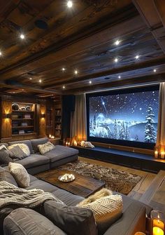 a living room filled with furniture and a flat screen tv sitting on top of a wooden wall