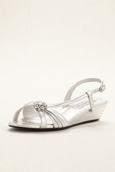 a woman's silver wedged sandal with jeweled buckles and ankle strap