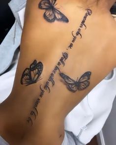 a woman's back with butterflies on it and the words written in cursive writing