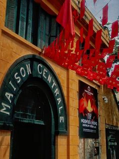 a building with red flags hanging from it's side