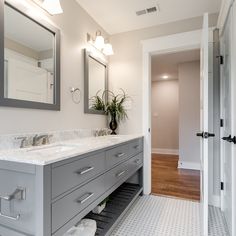 a bathroom with two sinks and a large mirror