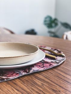 a white plate sitting on top of a wooden table