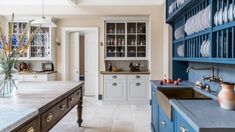 a kitchen with blue cabinets and white countertops is seen in this image from the inside