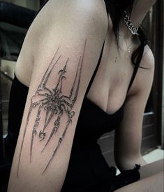 a woman with a spider tattoo on her arm