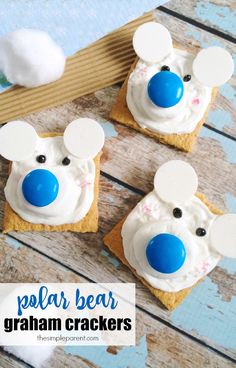 three small crackers with white frosting and blue nose on them