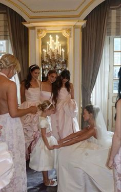 a group of women standing next to each other in front of a bridesmaid