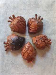 four carved wooden figurines sitting on top of a table