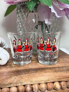 two shot glasses sitting on top of a wooden table