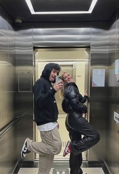 two people taking a selfie in an elevator