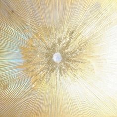 an abstract background with gold and white lines in the shape of a starburst