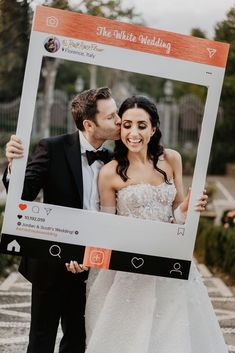 a newly married couple holding up a photo frame